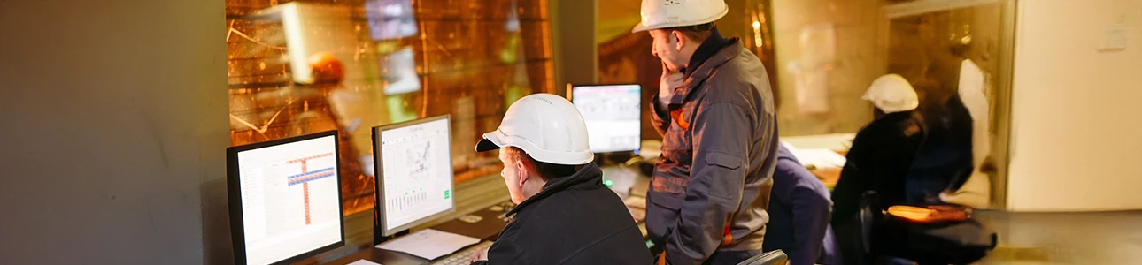 Engineers monitoring connected automation systems in a control room